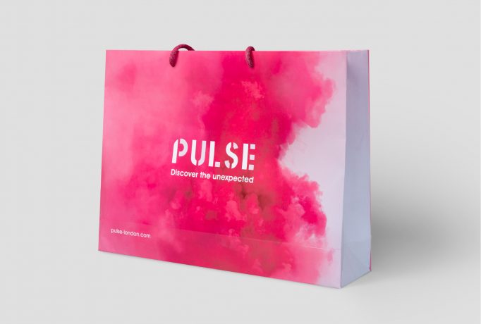 pink coloured cloud of smoke that says ‘PULSE - Discover the unexpected’ on a paper bag