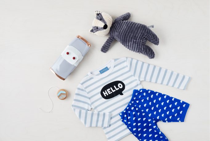 grey and white stripped pyjama, racoon teddy and toys