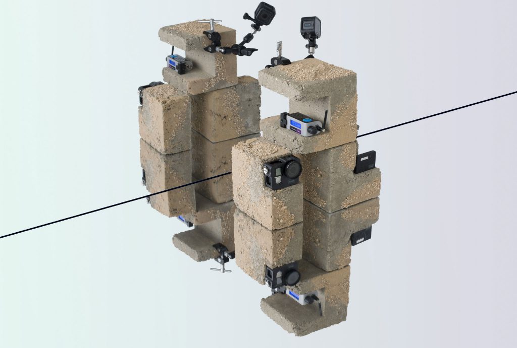 camera positioned on concrete blocks with sand texture