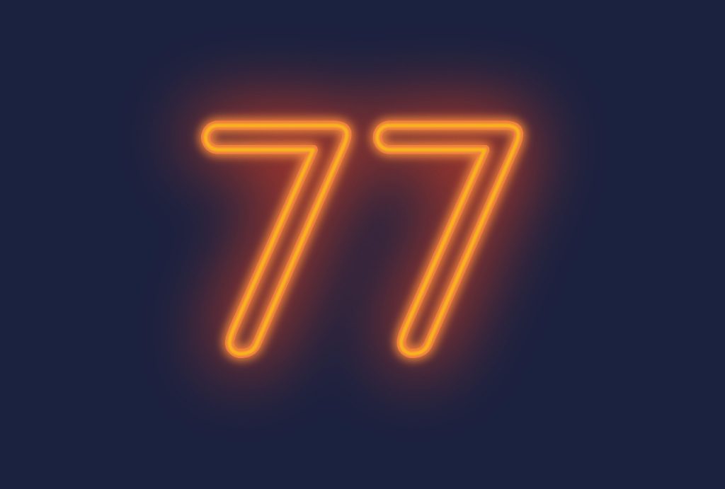 orange neon lights forming the number 77 on a dark blue background
