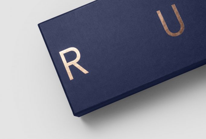 close up on a dark blue box with copper ‘RUX’ logo
