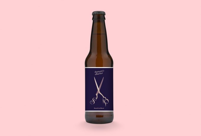 front view of a beer bottle with a dark violet label with a old-rose illustration of SB emblazoned pair of scissors