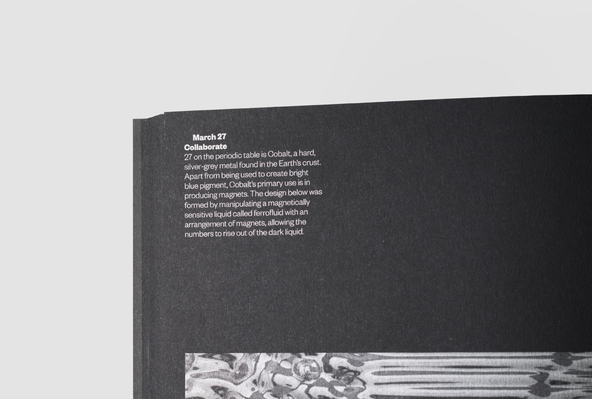 close up of a silver written text of ‘March 27, Collaborate’ in a black book
