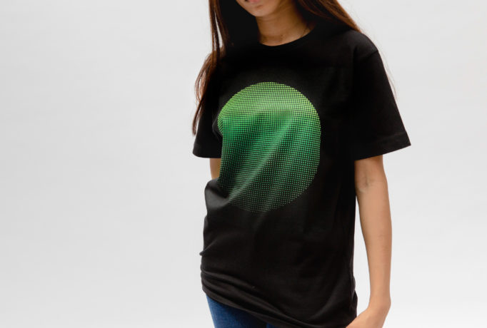 woman wearing black t-shirt with printed green circle