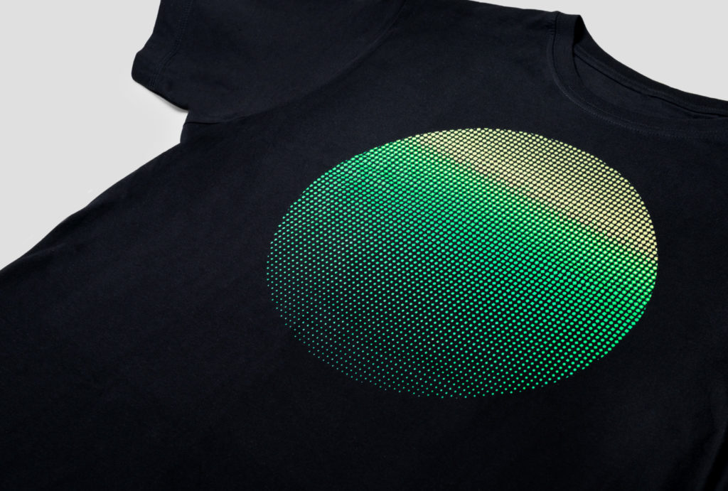 close up on black t-shirt with printed green circle