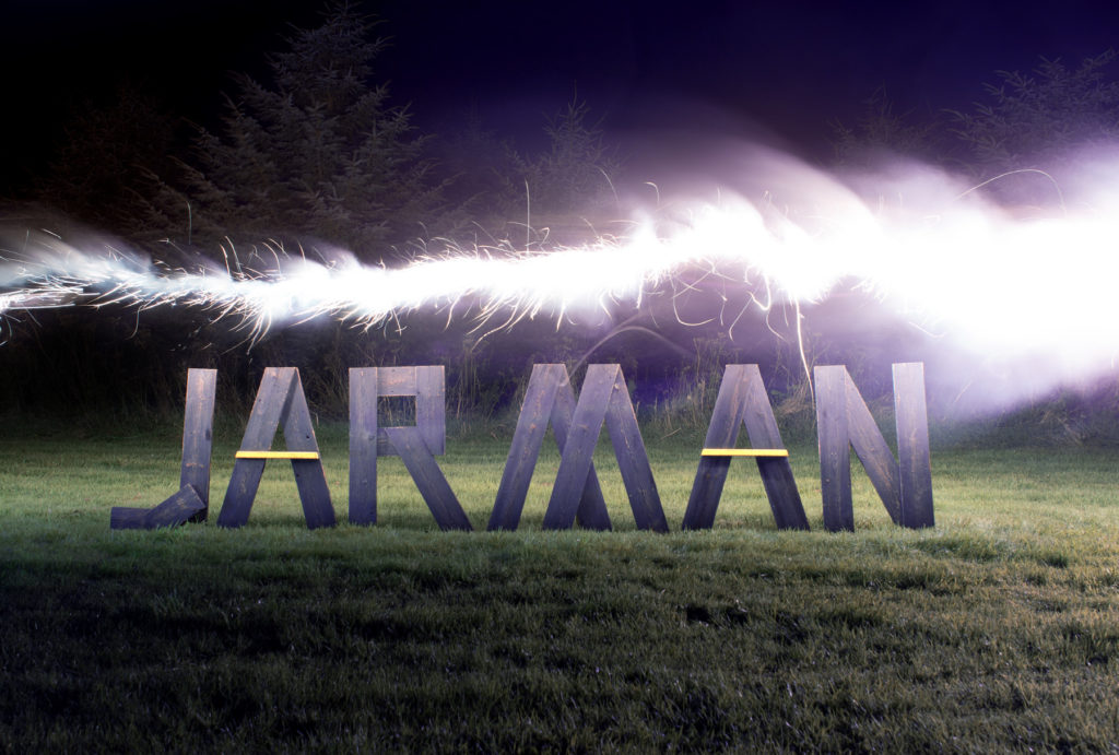 art-direction for JARMAN awards consisting of wooden letters in a dark field, illuminated by a flair